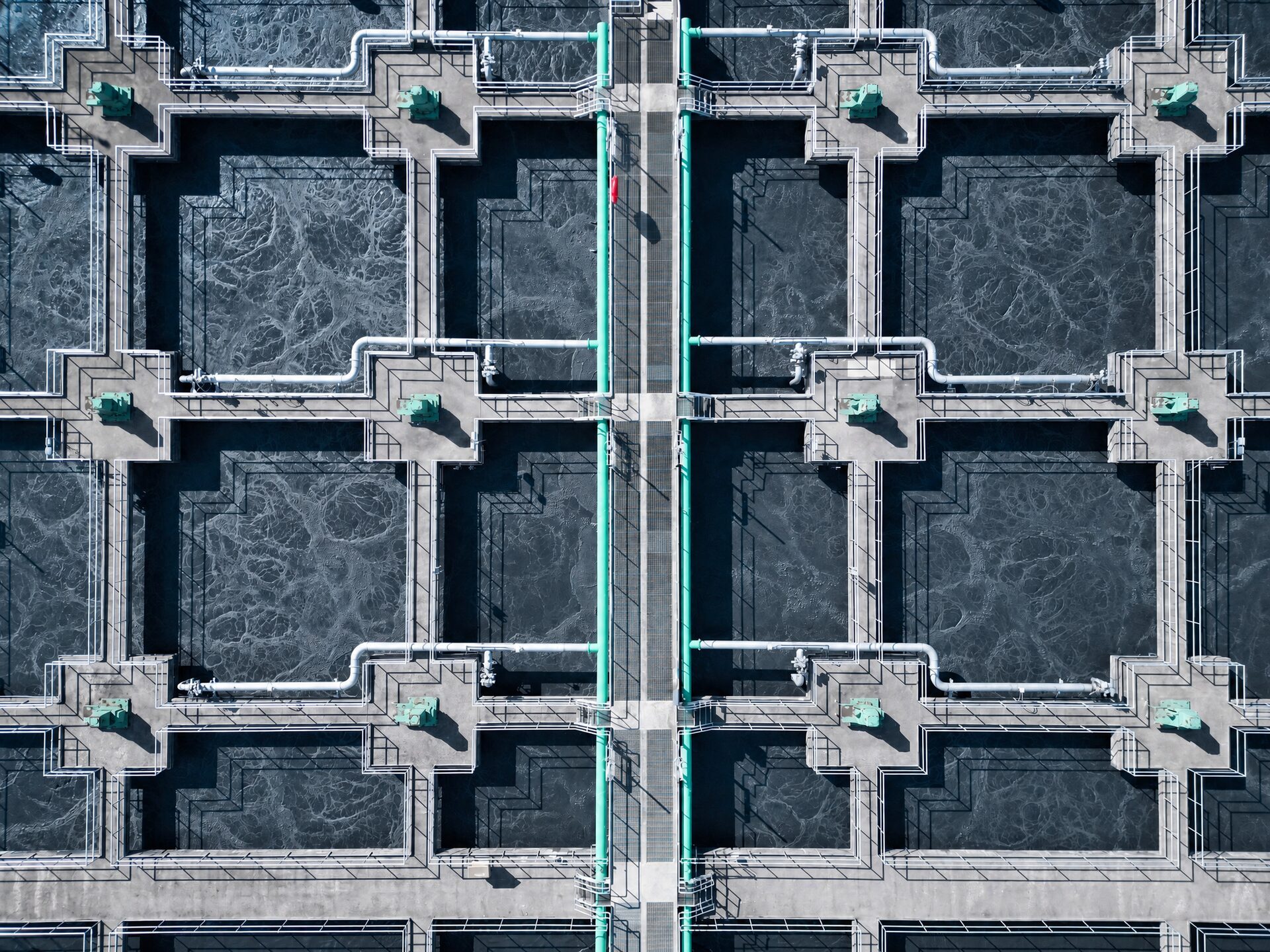 Aerial view of activated sludge aeration basins with brown mixed liquor at a secondary wastewater treatment plant