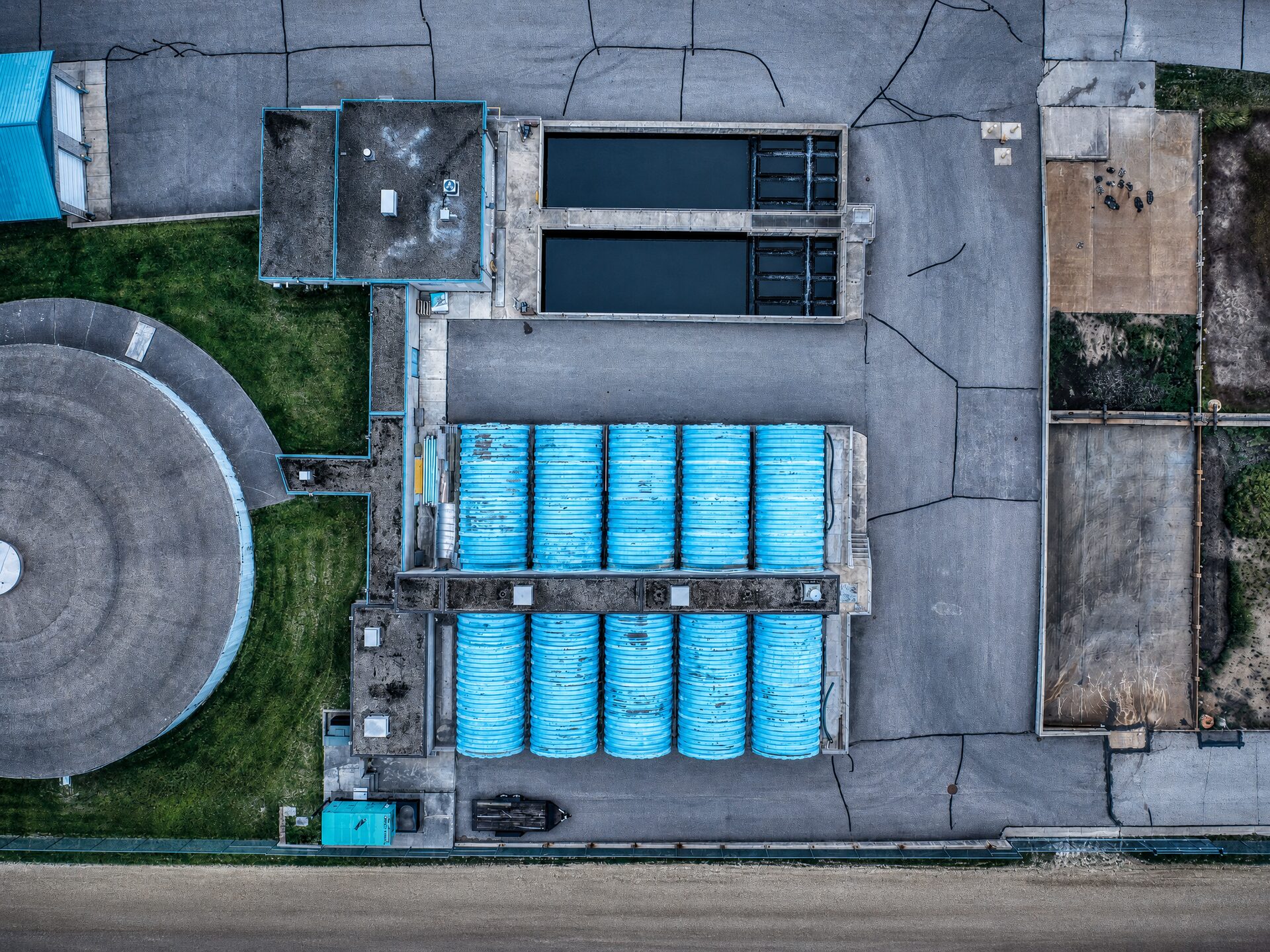 Aerial view of cylindrical biological treatment reactor tanks at a wastewater treatment plant