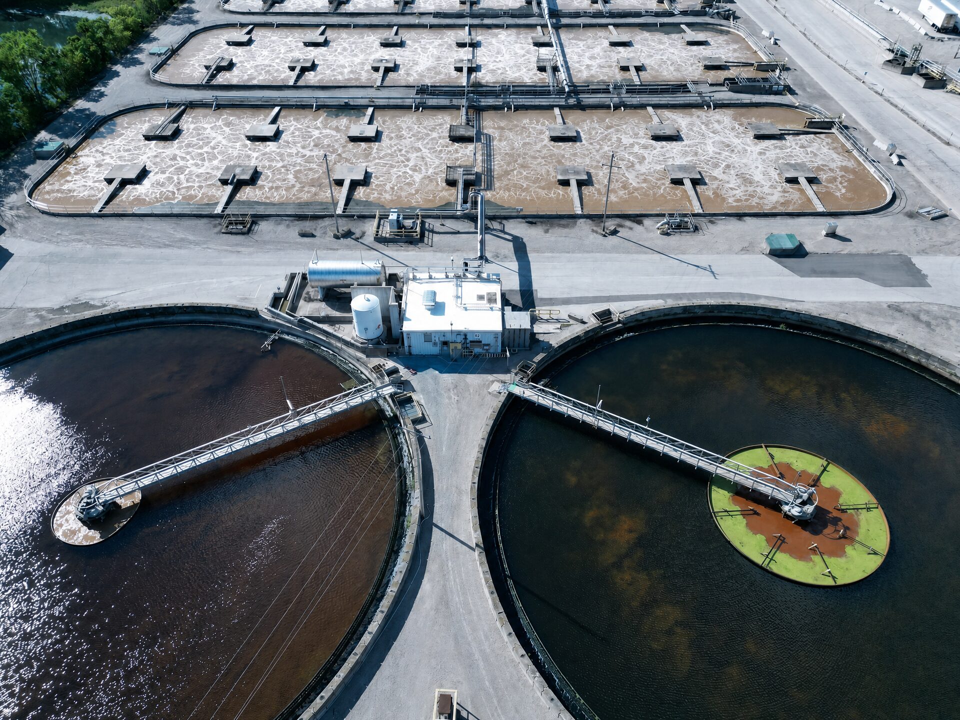 Aerial view of secondary clarifiers and activated sludge aeration basins at a biological wastewater treatment plant